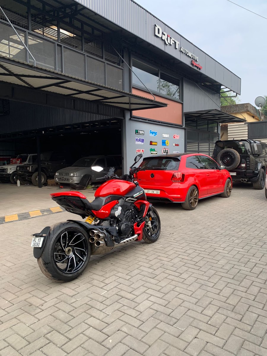 The Drift Automotive Performance Garage building on the Tirur–Calicut road — Ducati Diavel, VW Polo and a Jeep Wrangler parked out front