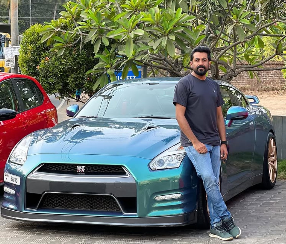 Saleem with a customer's modified Nissan GT-R outside the workshop
